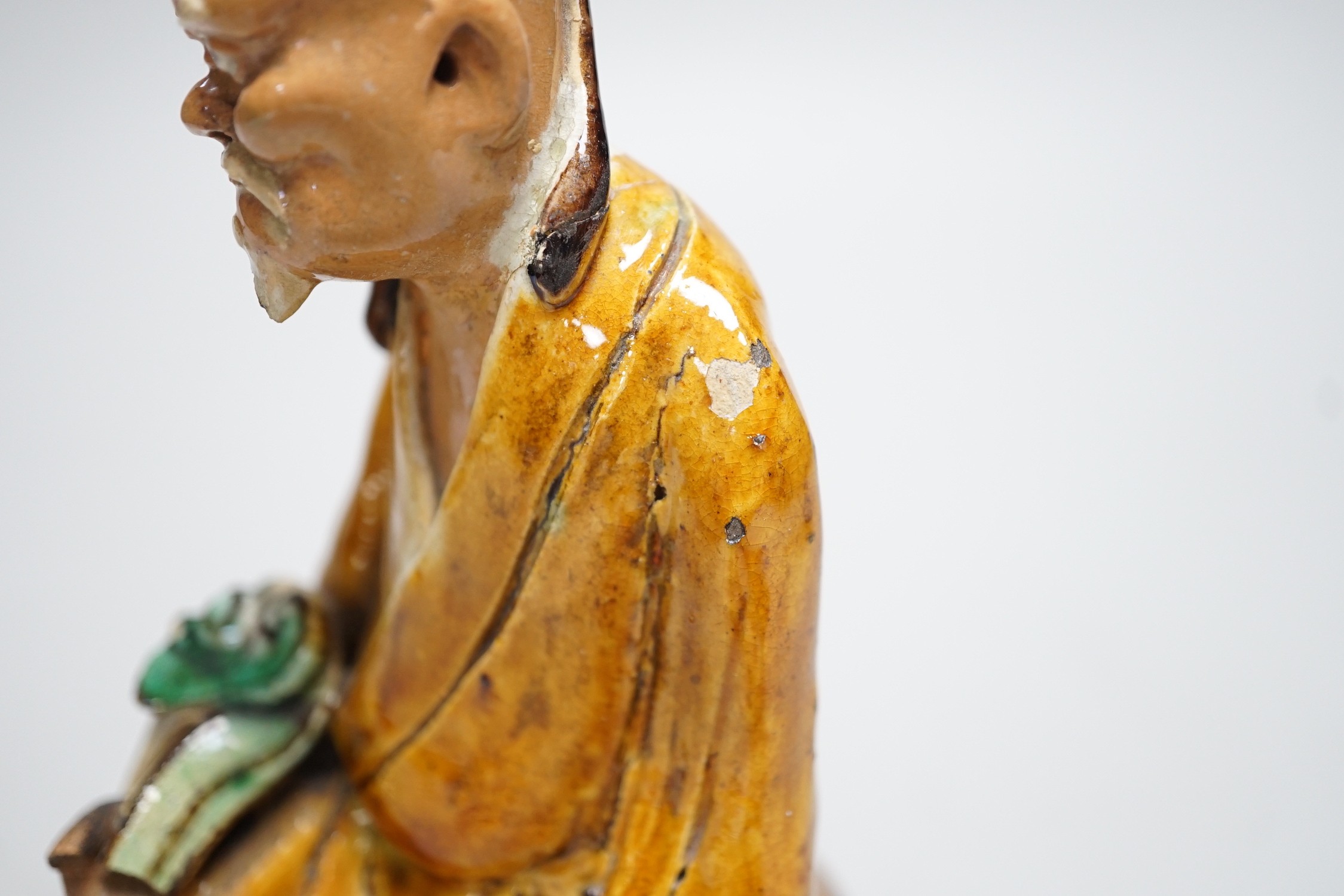 A Chinese Shiwan figure of a sage, possibly 18th century, 19cms high